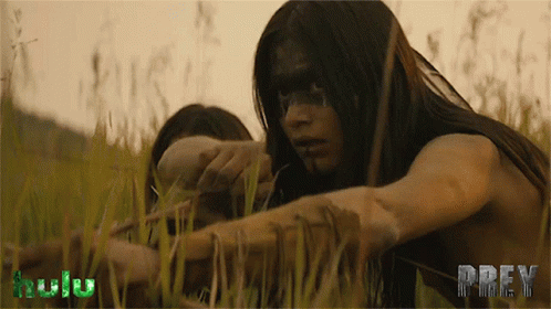 A Woman In A Field With The Word Prey On The Bottom Right GIF