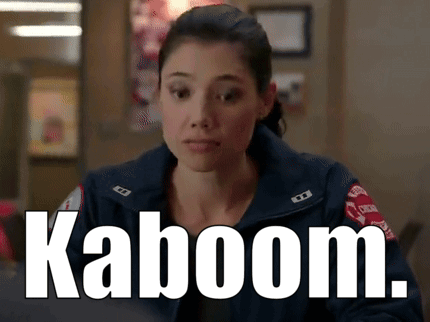A Woman In A Firefighter Uniform Has The Word Kaboom On Her Chest GIF