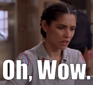 A Woman In A Firefighter Uniform Is Sitting At A Table With The Words Oh Wow Written Above Her . GIF