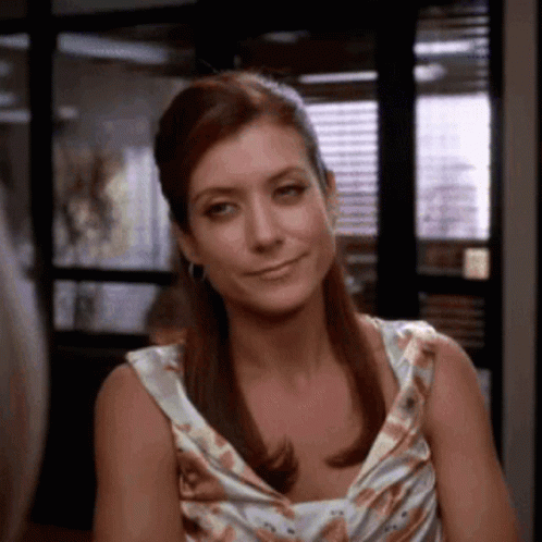 Woman In Floral Dress Smiling For Camera GIF