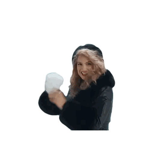 a woman in a fur coat is blowing up cotton candy