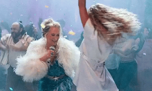 A Woman In A Fur Coat Is Singing Into A Microphone While Dancing In A Club . GIF