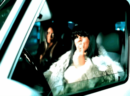 A Woman In A Fur Coat Is Sitting In A Car GIF