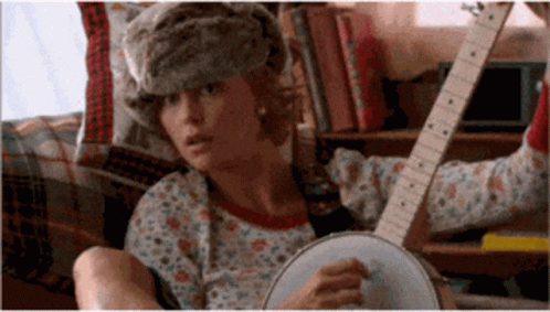 Woman In Fur Hat Playing Banjo And Guitar GIF