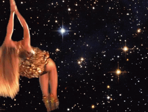 A Woman In A Gold Dress Is Dancing In The Stars GIF