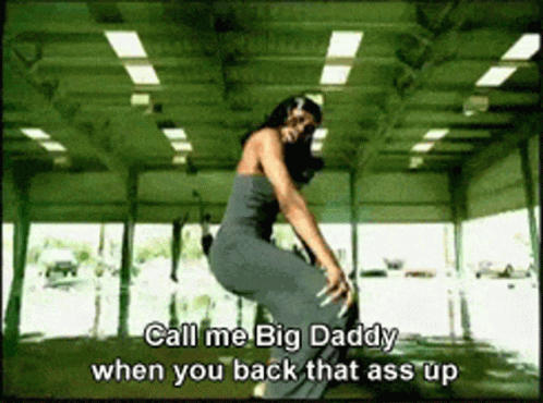 A Woman In A Gray Dress Is Squatting Down With The Words Call Me Big Daddy When You Back That Ass Up GIF