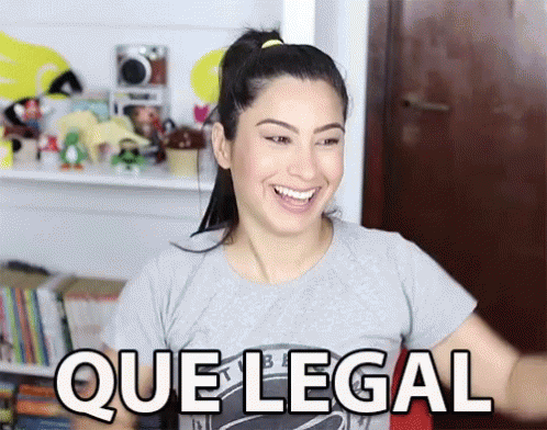 A Woman In A Gray Shirt Is Smiling And Says Que Legal GIF