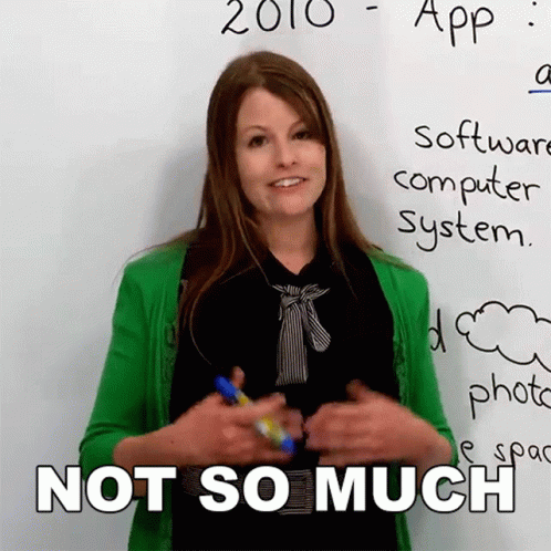 A Woman In A Green Cardigan Stands In Front Of A White Board That Says 2010 App Software Computer System GIF
