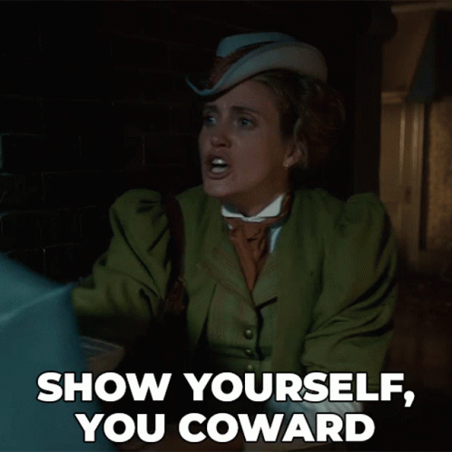 A Woman In A Green Coat And Hat Says " Show Yourself You Coward " GIF