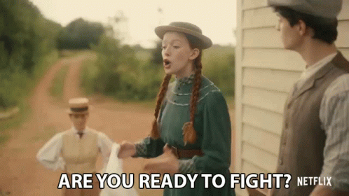 A Woman In A Green Dress And Hat Is Standing Next To A Man And A Woman And Says Are You Ready To Fight ? GIF