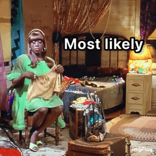 A Woman In A Green Dress Is Sitting In A Room With The Words Most Likely Written Above Her GIF