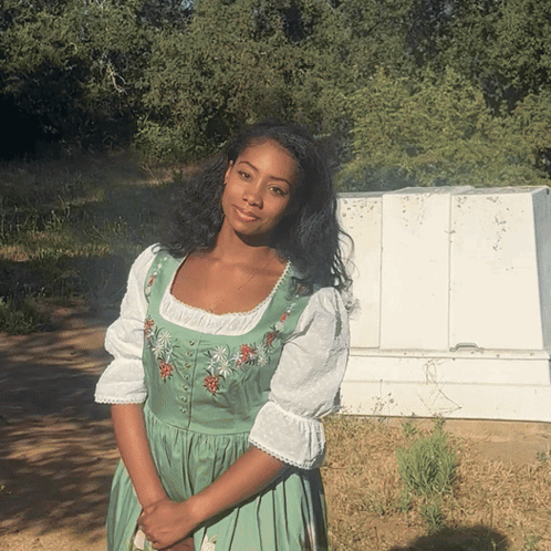 A Woman In A Green Dress With Flowers On It GIF