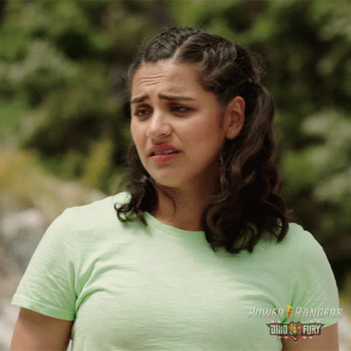 A Woman In A Green Power Rangers T-Shirt GIF