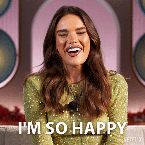 A Woman In A Green Sequined Dress Is Smiling And Says I 'M So Happy GIF