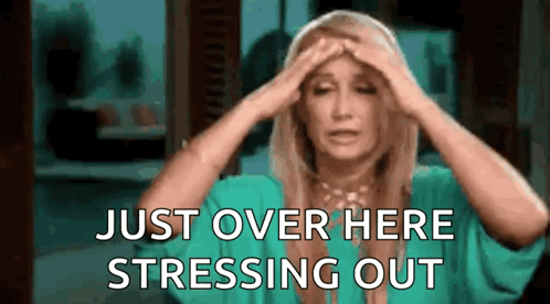 A Woman In A Green Shirt Is Holding Her Head And Saying `` Just Over Here Stressing Out '' . GIF