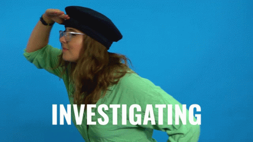 A Woman In A Green Shirt Is Investigating GIF