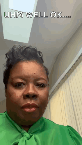 A Woman In A Green Shirt Is Making A Funny Face And Says `` Uhm Well Ok ... '' GIF
