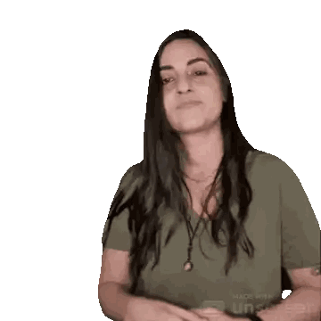 a woman in a green shirt is making a funny face with her hands