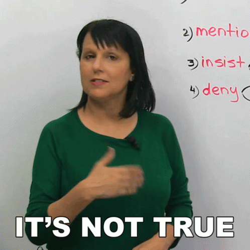 A Woman In A Green Shirt Says It 'S Not True In Front Of A Whiteboard GIF