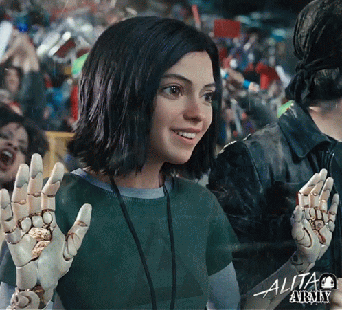 A Woman In A Green Shirt With The Word Alita Army Written On It GIF
