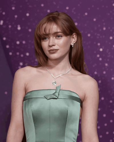 A Woman In A Green Strapless Dress With A Necklace GIF