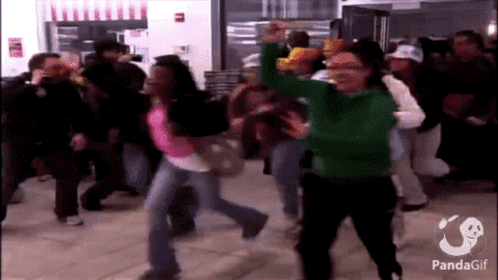 A Woman In A Green Sweater Is Dancing In A Crowd With A Panda Gif Watermark GIF