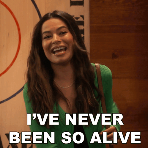 A Woman In A Green Sweater Is Laughing And Says I 'Ve Never Been So Alive GIF