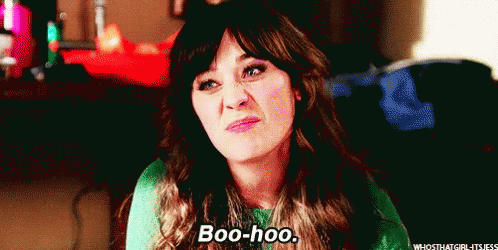 A Woman In A Green Sweater Is Making A Funny Face And Saying Boo-Hoo . GIF