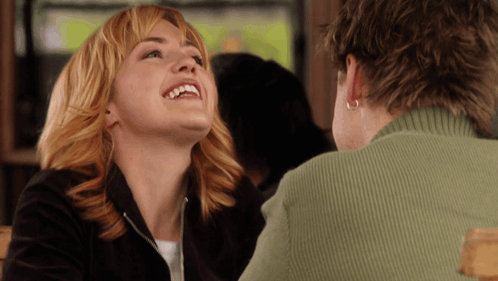 Woman In Green Sweater Laughing Looking Up GIF