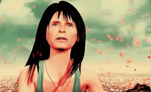 A Woman In A Green Tank Top Is Looking Up At Something GIF