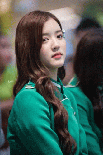 A Woman In A Green Uniform Has The Word Bmw Written On Her Shoulder GIF