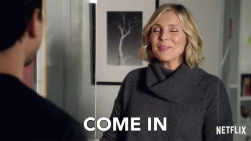 a woman in a grey sweater says come in in a netflix ad