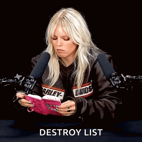A Woman In A Harley Davidson Jacket Reads A Book GIF