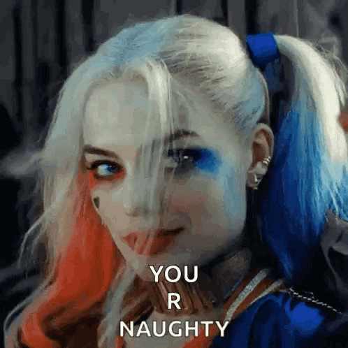 Woman In Harley Quinn Costume Smiling Naughty GIF