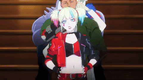 A Woman In A Harley Quinn Costume Is Standing Next To A Man On A Set Of Stairs . GIF