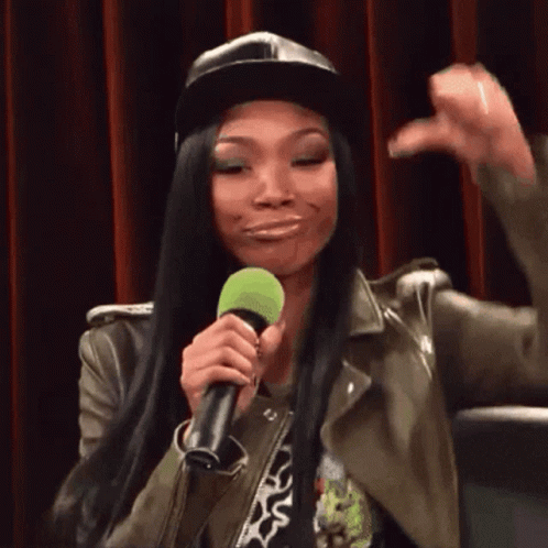 Woman In Hat Holding Microphone Making Face GIF
