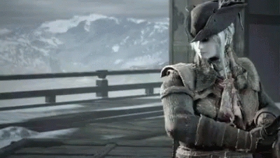 A Woman In A Hat Stands On A Balcony Overlooking A Snowy Mountain Range GIF