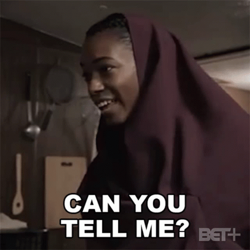A Woman In A Hijab Is Smiling And Asking Can You Tell Me GIF