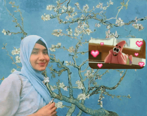 A Woman In A Hijab Is Standing In Front Of A Tree With Flowers GIF