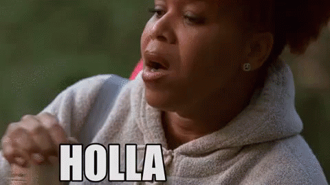 A Woman In A Hoodie Is Making A Funny Face And The Word Holla Is On Her Face . GIF