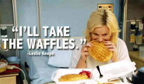 A Woman In A Hospital Bed Eating A Waffle With A Quote From Leslie Knope GIF