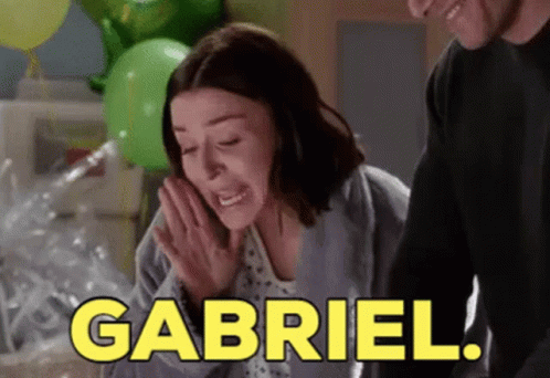 a woman in a hospital gown is crying while a man stands behind her and says gabriel .