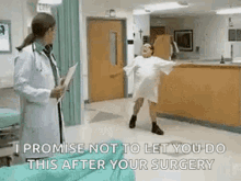 A Woman In A Hospital Gown Is Dancing In Front Of A Doctor Who Is Holding A Clipboard . GIF