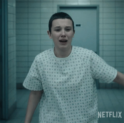 A Woman In A Hospital Gown With A Netflix Logo Behind Her GIF