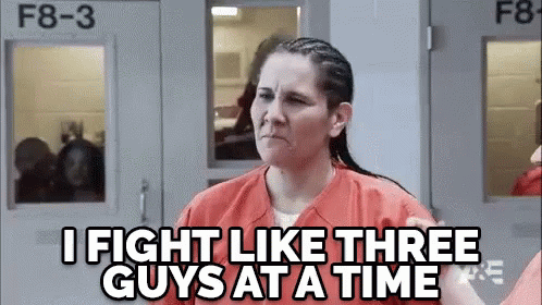 a woman in a jail cell is making a face and saying `` i fight like three guys at a time '' .