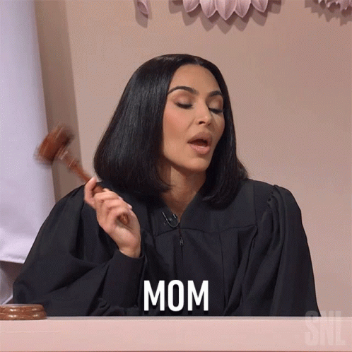 A Woman In A Judge 'S Robe Is Holding A Gavel And The Word Mom Is On The Screen GIF