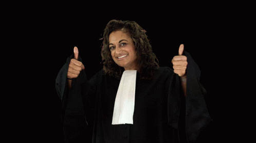 a woman in a judge 's robe is holding up a glass of wine