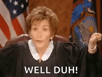 A Woman In A Judge 'S Robe Is Sitting In Front Of An American Flag And Saying `` Well Duh '' . GIF