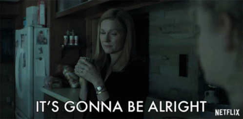 a woman in a kitchen holding a cup with the words it 's gonna be alright on the bottom