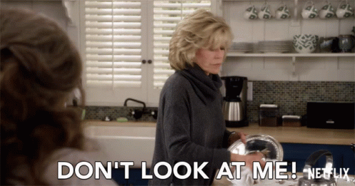 A Woman In A Kitchen Says " Don 'T Look At Me Netflix " GIF
